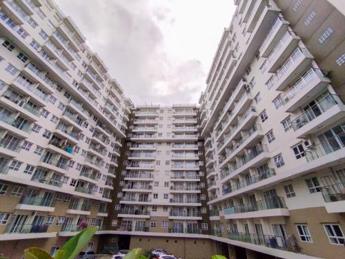 two tall apartment buildings with balconies at Amazing 1BR Apartment Gateway Pasteur By Travelio in Bandung