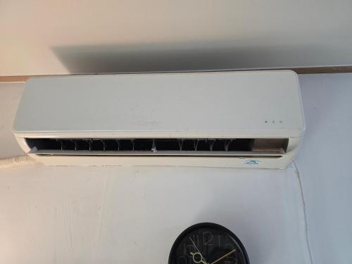 a white microwave oven sitting on top of a clock at Detached house with a large yard, 15 minutes from the sea in Hwaseong in Hwaseong