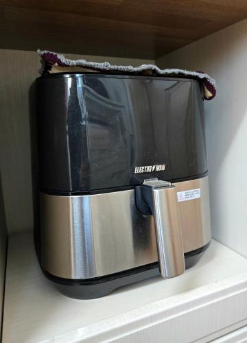 a toaster oven sitting on top of a shelf at Detached house with a large yard, 15 minutes from the sea in Hwaseong in Hwaseong