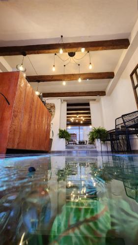 an indoor swimming pool in a room with water at Piedra Negra Boutique Hotel in San Cristóbal de Las Casas