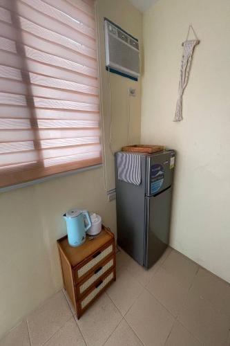 a kitchen with a small refrigerator and a table at Surfside hostel LU Surftown in San Juan