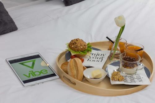 a tray of food with a sandwich and bread and drinks at B&B Vibe in Split