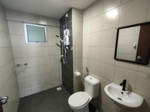 a bathroom with a toilet and a sink and a mirror at Jalil homestay by MyPOCKETT in Kampong Bohol