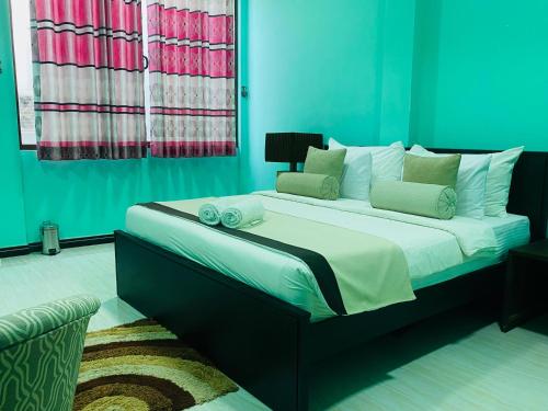 a bedroom with a large bed in a room at Blue Harbour Inn in Trincomalee