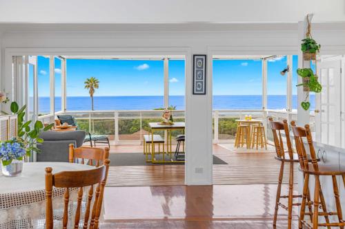 a living room with a view of the ocean at Sun Catcher - ocean views, walk to beach, lake, cafés, shops in Lake Cathie