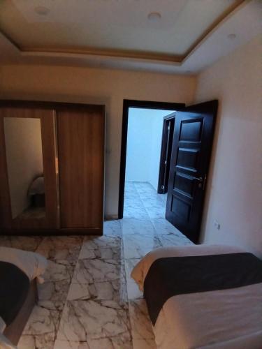a room with two beds and an open door at dream house hotel in Jerash