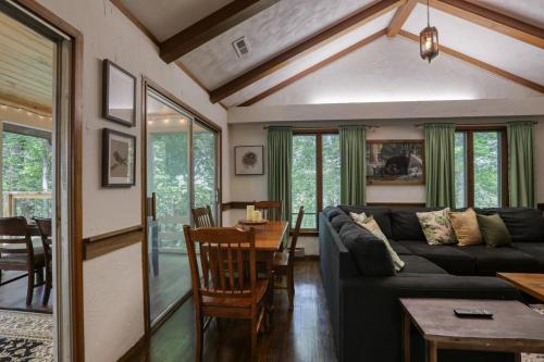 a living room with a couch and a table at Treetop Hideaway - Summer Escape with HOT TUB in Gatlinburg