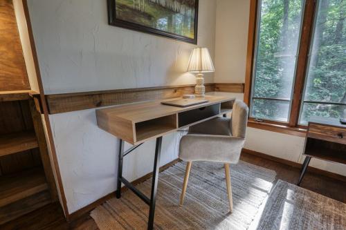 a desk with a lamp and a chair in a room at Treetop Hideaway - Summer Escape with HOT TUB in Gatlinburg