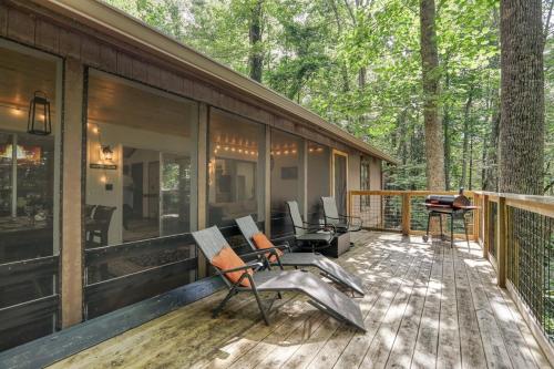 a screened in porch of a house in the woods at Treetop Hideaway - Summer Escape with HOT TUB in Gatlinburg