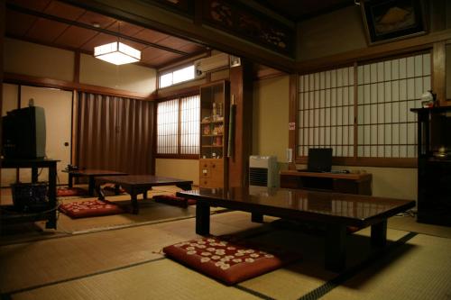 a room with two ping pong tables in it at Magome Chaya in Nakatsugawa