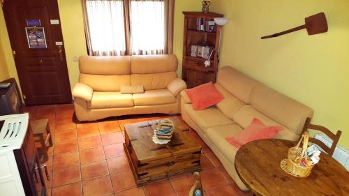 a living room with a couch and a table at Madre Terra in La Puebla de la Sierra