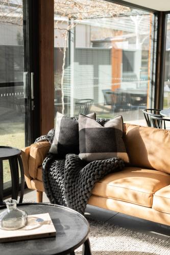 a living room with a couch and a table at Athlete's Retreat - 21A Service Street in Porepunkah