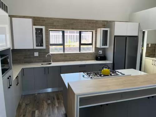 a kitchen with a sink and a stove top oven at Island View in Mossel Bay in Mossel Bay