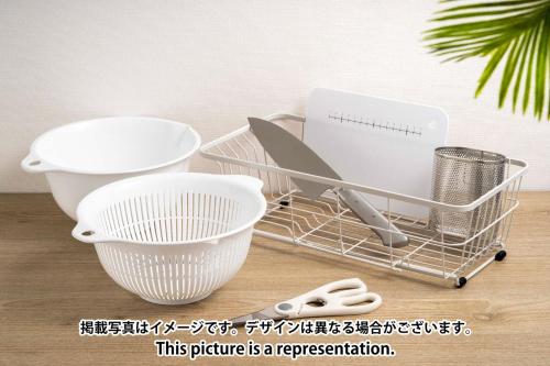 a shopping cart with various kitchen utensils on a table at Daffitto Mitaka in Mitaka