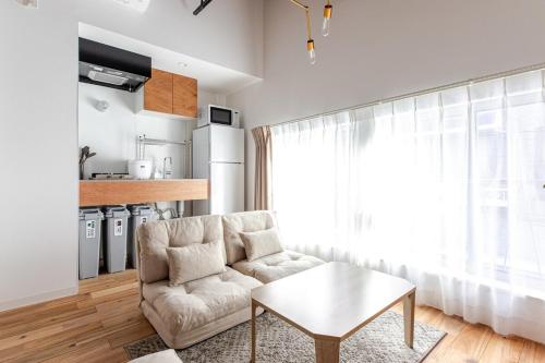 a living room with a couch and a table at SSr大和町1丁目 in Tokyo