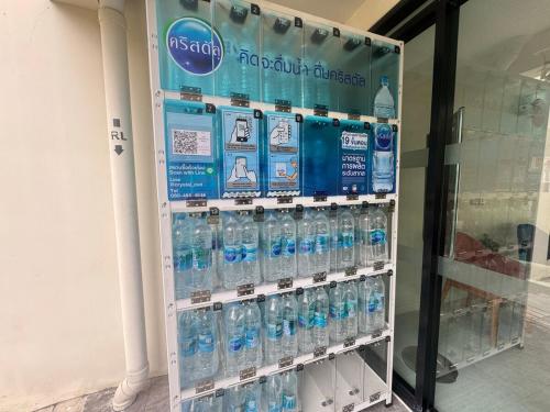 a vending machine filled with lots of bottles of water at Sunlit Nest Sukhumvit in Ban Khlong Samrong