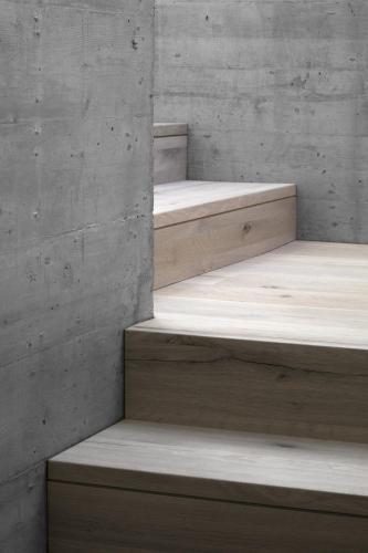 a concrete wall with three bunk beds in a room at Hotel Gardenazza in Badia