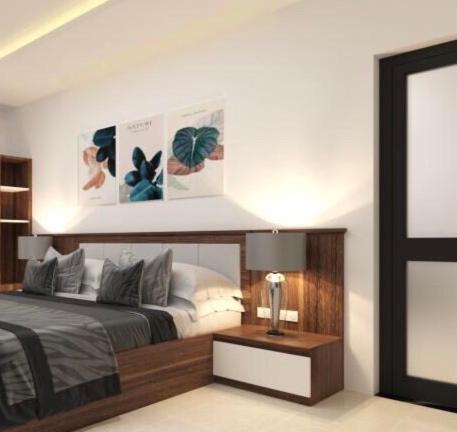 a bedroom with a bed and a table with a lamp at Tamcoc Golden Shine Homestay & Cafe in Ninh Binh