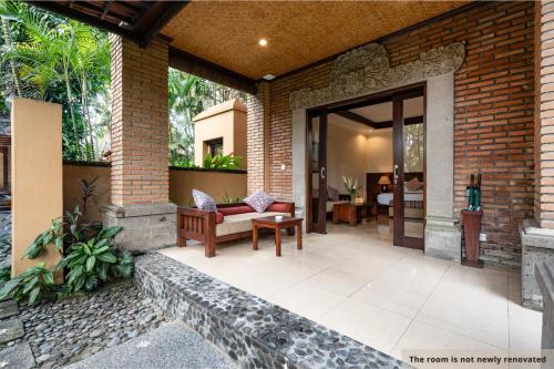 an open door to a patio with a couch at Svarga Bebek Villas in Ubud