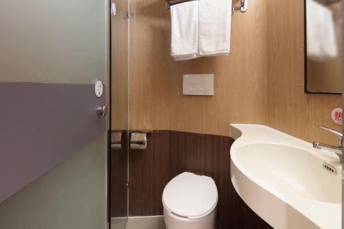 a bathroom with a white toilet and a sink at Mcsrh Hotel-Chengdu Chunxi Road in Chengdu