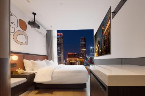 a hotel room with a bed and a view of a city at Mcsrh Hotel-Chengdu Chunxi Road in Chengdu