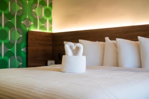 a white basket sitting on top of a bed at The Alice Hotel in Tucson