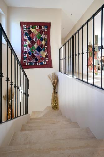 a stairway with a mosaic art on the wall at La Villa KEF in Lambesc