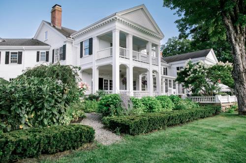 a large white house with a garden in front of it at The White House Inn in Wilmington