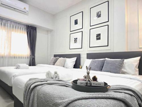 a bedroom with two beds and a table on the bed at Arun Sa wad - Chinatown in Bangkok