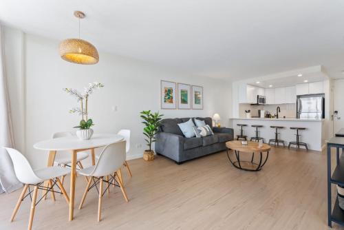 a living room with a couch and a table at Oceanfront Renovated Getaway in Waikiki in Honolulu