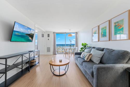 a living room with a couch and a table at Oceanfront Renovated Getaway in Waikiki in Honolulu