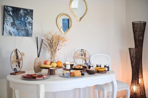 a white table with food on top of it at La Villa KEF in Lambesc
