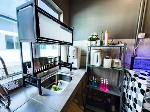 a kitchen with a sink in a room at NDD Homestay in Sitiawan