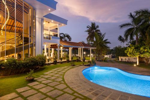 an exterior view of a house with a swimming pool at Regal Rivera Villa in Negombo
