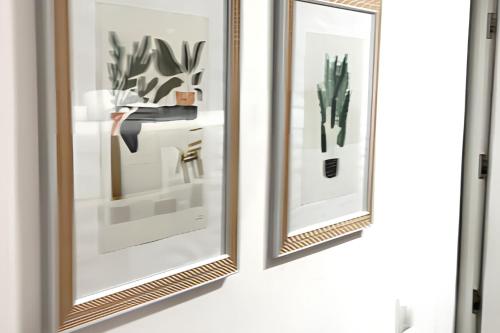 two mirrors hanging on a wall with plants at Charming House in Chiclana de la Frontera with Terrace in Chiclana de la Frontera