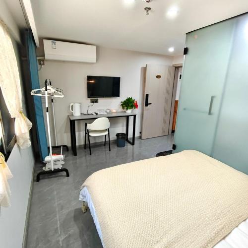 a hospital room with a bed and a desk with a computer at Wangxian Valley Qingchuanxingguan - Wangxian Valley Scenic Area in Jiangcun