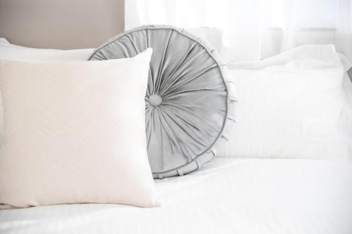 a bed with a white pillow and a wheel headboard at Miraie Yokkaichi Takasagocho in Yokkaichi