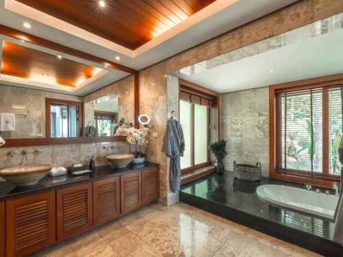 a bathroom with two sinks and a tub at Baan View Talay - Sea View Zenith Villa By Elite Havens in Surin Beach