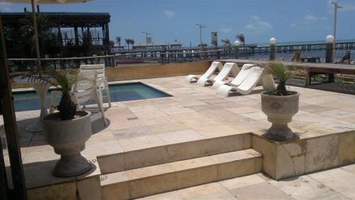 a swimming pool with chairs and a pool slide at Vista Maravilhosa 706 in Fortaleza