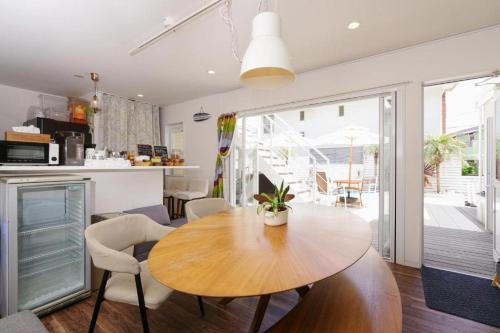 a kitchen and dining room with a wooden table and chairs at KIYAZA RESORT Kamakura in Kamakura