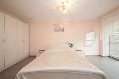 1 dormitorio blanco con 1 cama en una habitación en Kvartirov Apartments City, en Krasnoyarsk