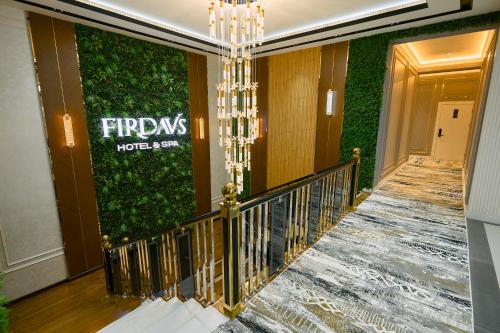 a staircase in a hotel with a green wall at FIRDAVS HOTEL in Navoi
