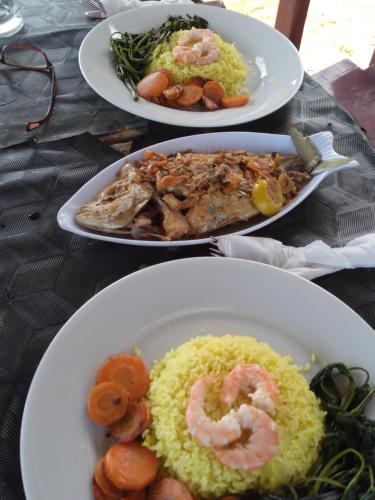 a table with three plates of food on it at Happy Beach Cabana in Hambantota