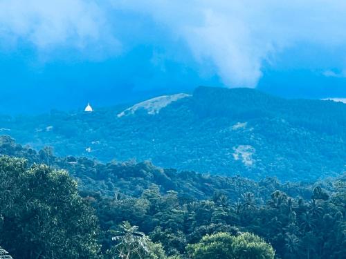 a view of a mountain with trees and a pyramid at Misty Haven A-Frame in Kandy