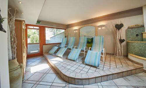 a group of blue chairs in a room at Hotel Wechselberger by Alpeffect Hotels in Saalbach Hinterglemm