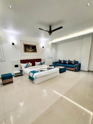 a large living room with two beds and a couch at Hotel Paras Chittorgarh in Chittaurgarh