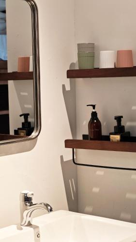 a bathroom with a sink and a mirror at Once Linya Xiaoyuan in Chongqing