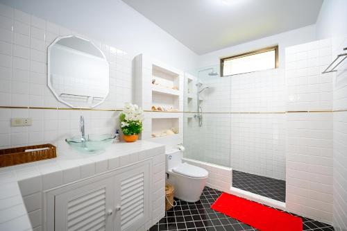 a white bathroom with a sink and a toilet at Sriwaree Pool Villa Khao Lak - 8 meters pool - 3 bedroom - 2 bath in Khao Lak