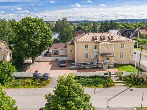 an aerial view of a large yellow house at Lillan Hotel & Kök in Tampere