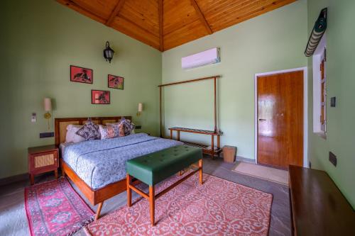 a bedroom with a bed and a wooden ceiling at The Beehad Sariska in Tehla